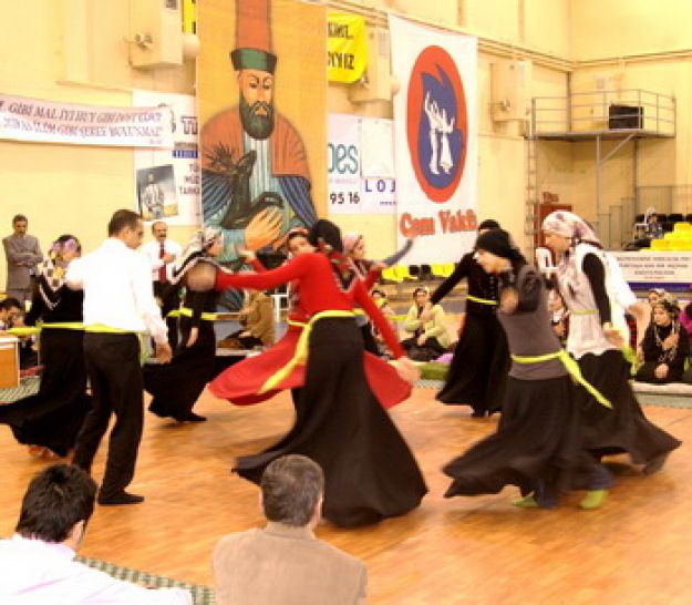 Glinda in Wicked the musical in a blue ball gown in front of a blue and black background with bubbles.
